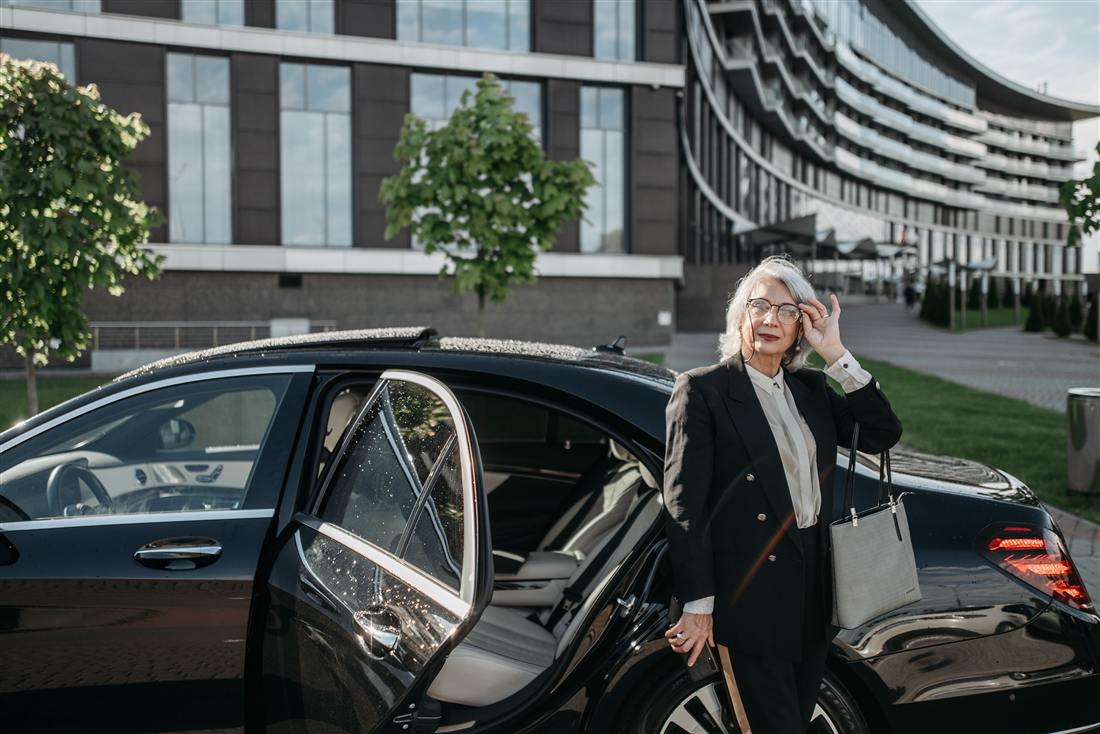 A chauffeur opening the door for a client